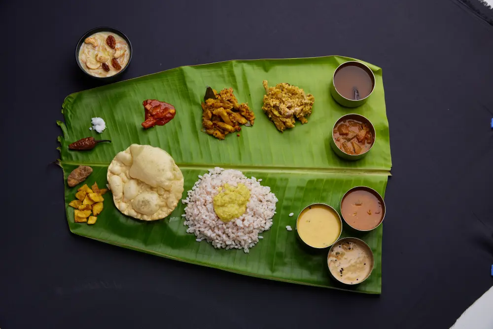 Kerala sadya served on a banana leaf with rice, curries and traditional sides